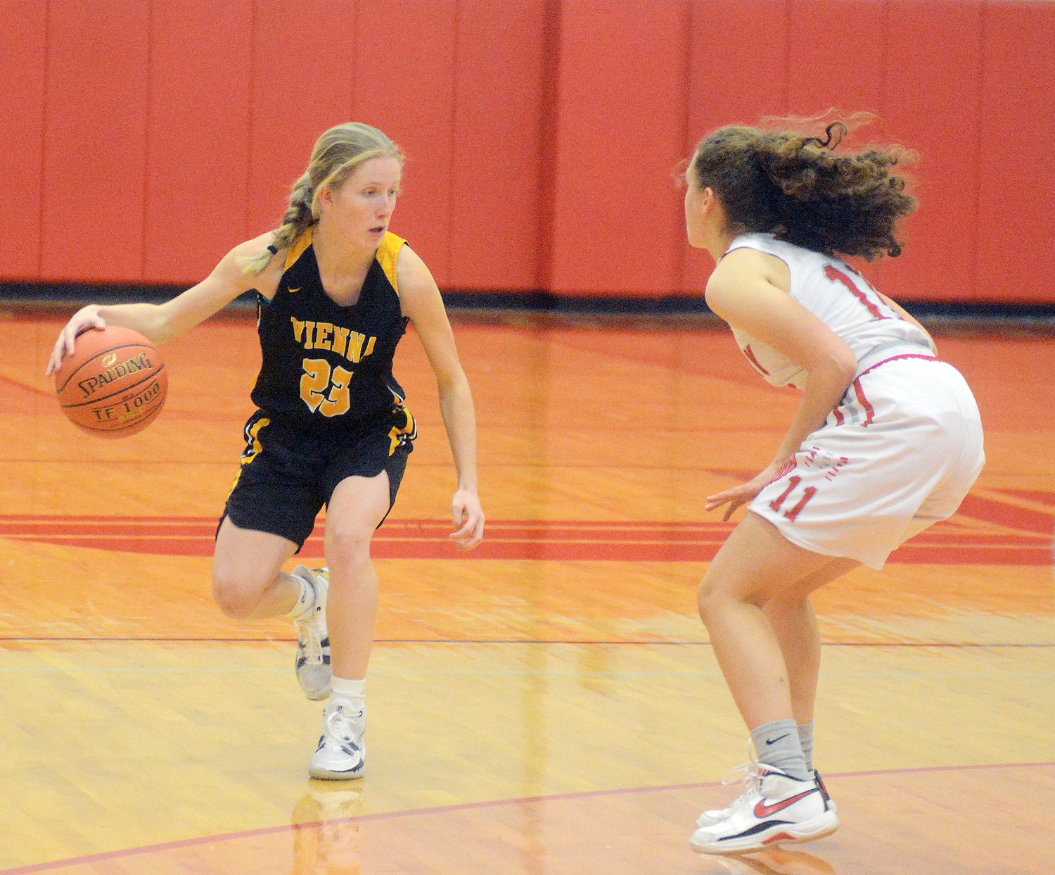 Kadence George (left) handles the basketball on offense for Vienna in the semifinals Saturday morning against the host Lady Lions from Calvary Lutheran.
